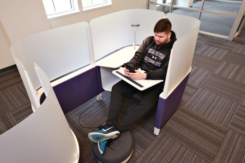 TCU student Benjamin Adams sits in a Brody WorkLounge by Steelcase in the Mary Couts Burnett Library. Photo by Carolyn Cruz