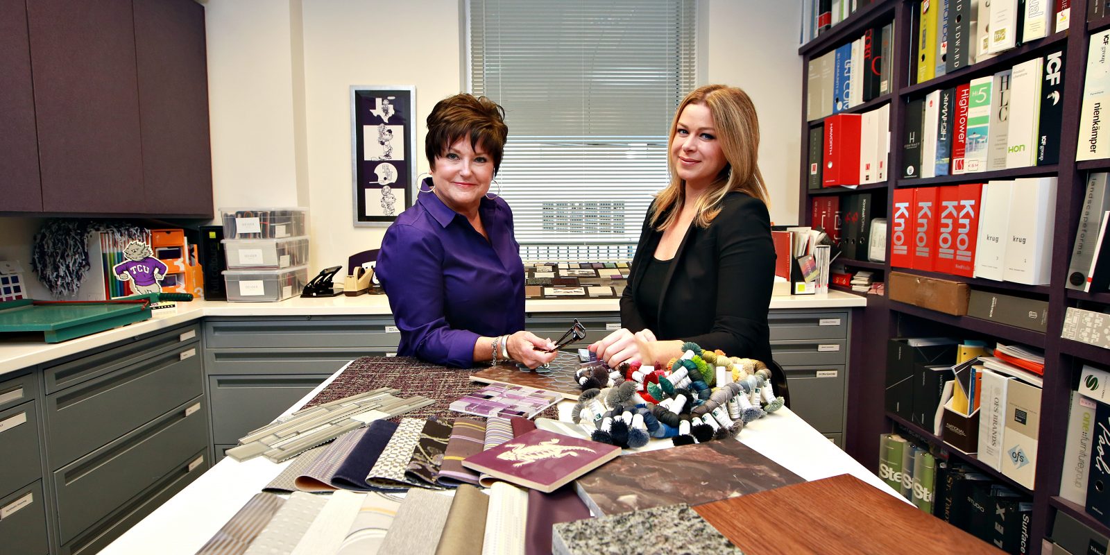 TCU interior designers Lisa Aven, left, and Stephanie McPeak, right, pose in their office in the Physical Plant building. Photo by Carolyn Cruz