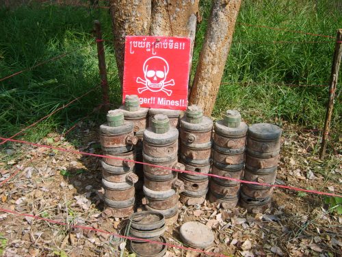 Several stacks of landmines that Cambodian Self-Help Demining (CSHD) has located and unearthed to be disarmed. 