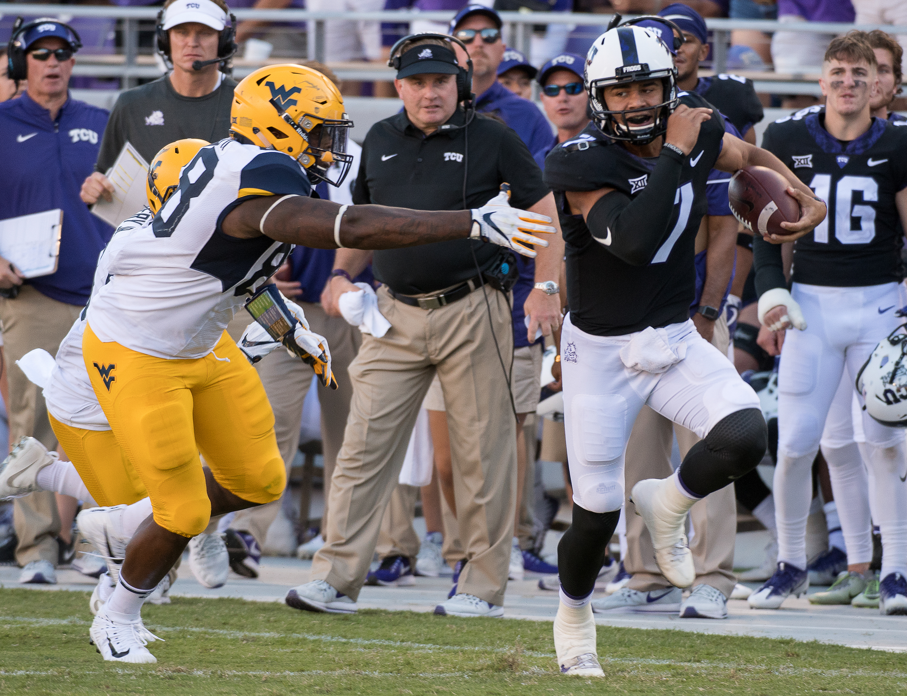 Quarterback Kenny Hill escapes the grasp of Mountaineer Adam Shuler II at the 25 yard line for Hill's first career reception. Photo by Glen E. Ellman