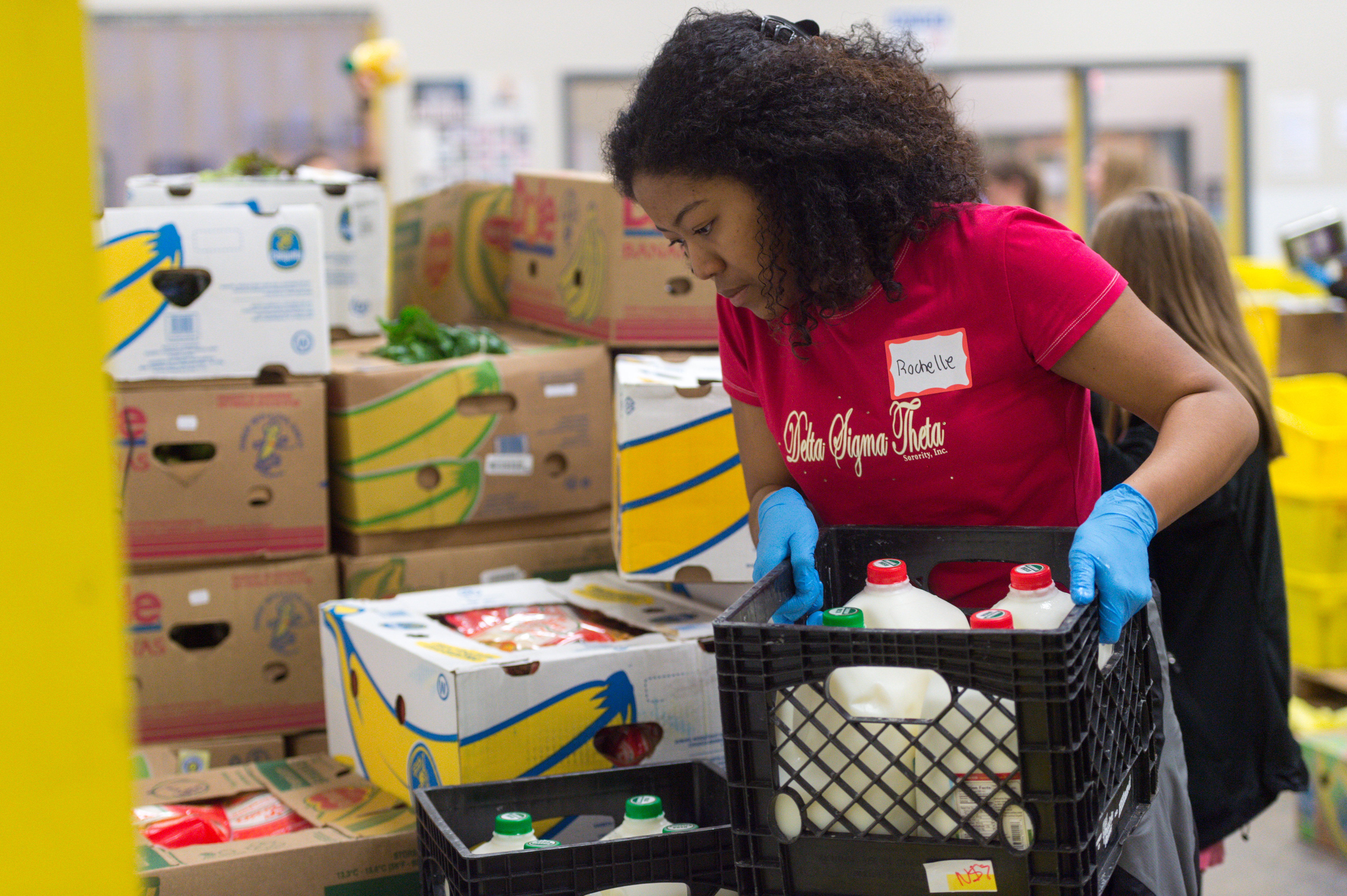 TCU criminal justice major Rochelle Smith sorts donations while volunteering at the Tarrant Area Food Bank in March. Photo by Leo Wesson