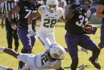 Sewo Olonilua (#33) escapes a tackle in the November game against Baylor. Photo by Glen E. Ellman