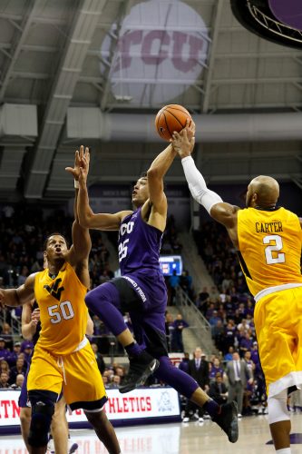 Alex Robinson leaps for a basket against West Virginia. The guard finished with a game-high 17 points and a season high seven rebounds. Courtesy of TCU Athletics | Photo by Sharon Ellman