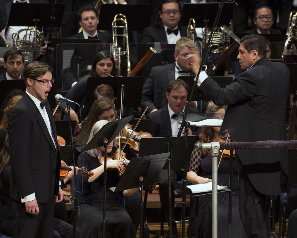 Germán Gutiérrez (far right) conducts the TCU Symphony Orchestra and the TCU Chorale in the world premiere of Cantata Para la Paz during the 11th Latin American Music Festival at TCU. At left, Nate Mattingly, bass-baritone, sings solo during the piece. Cantata para la paz was composed by Gutiérrez’s mentor, the late composer Roque Cordero. Photo by Beatriz Terrazas