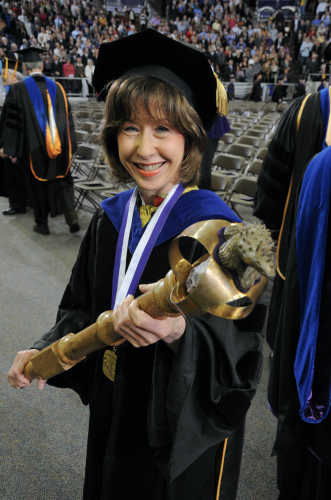 Linda Hughes entering a commencement ceremony with the TCU mace. Photo by Glen E. Ellman