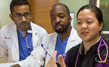 Dr. Jocelyn Zee, right, goes over a procedure with medical students Rubin Varghese (left) and Theron Bauman at John Peter Smith Hospital in Fort Worth.