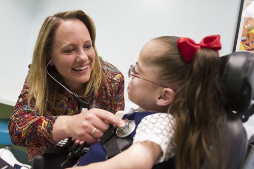 Dr. Karen Schultz, medical director of pediatric pulmonary services, listens to Faith Walthall's heart and lungs at Cook Children's. Photo by Mark Graham