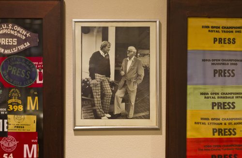A photo of Dan Jenkins with golfer Jack Nicklaus hangs among the press passes in Jenkins' home office. Photo by Mark Graham