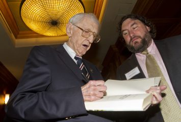 Dan Jenkins signs a copy of one of his books for Wright Thompso, senior writer for ESPN The Magazine, before the Dan Jenkins Medal Award event in Dallas. Photo by Mark Graham