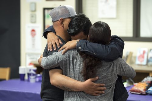 Brandon Carrasco Ballinas embraces his parents, Gabriel Carrasco and Sandra Ballinas, after he received an academic scholarship during the Community Scholars Program’s ceremony in April at Polytechnic High School in Fort Worth. Photo by Leo Wesson