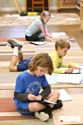 Henry Arnold (front) works on his lessons at the Montessori School of Fort Worth. Samuel Arnold, assistant professor of political science at TCU, said the school has been a “really great environment” for his son. Photo by Carolyn Cruz