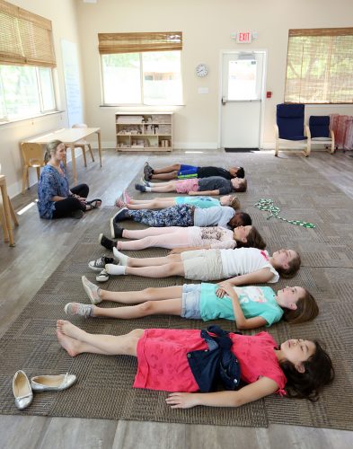 Jaye Poland leads students through mindful relaxation before their next class. Photo by Carolyn Cruz