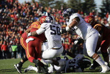 Defensive tackles Chris Bradley and Ross Blacklock stop a play on the gridiron in 2017 in Ames, Iowa. Photo courtesy of TCU Athletics