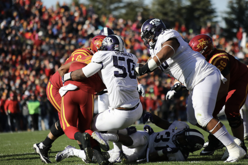 Defensive tackles Chris Bradley and Ross Blacklock stop a play on the gridiron in 2017 in Ames, Iowa. Photo courtesy of TCU Athletics