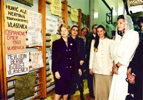 Swanee Hunt, left, with Queen Noor of Jordan, right, and other women in 1996 at the one-year commemoration of the Srebrenica Massacre in Bosnia. Women who lost a husband, father, son or other male relative in the massacre made the pieces in memory of the men killed. Courtesy of Swanee Hunt
