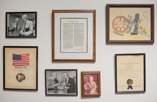 Among an assortment of plaques, photos and articles displayed on the wall of the Institute of Behavioral Research is a framed miniature American flag. The flag is accompanied by a certificate that states "THIS FLAG WAS ON BOARD APOLLO XIII DURING ITS FLIGHT AND EMERGENCY RETURN TO EARTH | APOLLO XIII | April 11-17, 1970" followed by the signatures of crew members James Lovell, Jack Swigert and Fred Haise and the official emblem of the Apollo XIII mission. Photo by Glen E. Ellman, August 14, 2018
