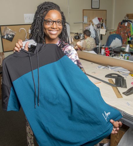 Jennifer James with one of her Active Ego activewear tops. Photo by Robert W. Hart