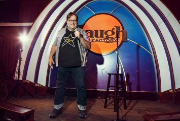 Los Angeles area arts editor and film critic Carl Kozlowski '93, photographed on stage at the iconic Hollywood Laugh Factory where he regularly performs stand-up comedy. Kozlowski is also the founder and host of the Radio Titans Podcast. Photo by Christine Gandolfo