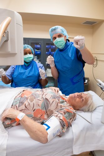 Brian H. Jacobs, a certified registered nurse anesthetist, and pain-management fellow Ruth Petros perform a medical procedure on Roberta Snyder. Photo By Joseph L. Murphy
