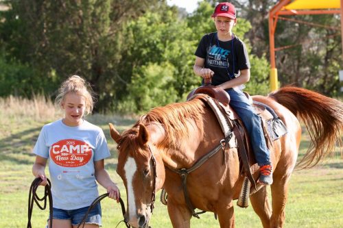 Avery and Owen lead a horse at Camp New Day in 2018. Campers say no one stares or is treated differently when is comes to diabetes management. Courtesy of Alison Lunsford/Diabetes Foundation of the High Plains 