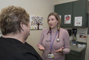 Dr. Alison Lunsford talks to a patient's mother about blood sugar levels. Photo by Ralph Duke