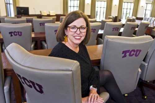 Amanda Stallings, associate vice chancellor for alumni relations, checks out the Justin Boardroom of the newly renovated and expanded Dee J. Kelly Alumni & Visitors Center. Photo by Mark Graham