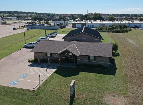 An aerial view of Ruth's Place Clinic in Granbury, Texas, shows the metal structure behind the brick house that is the most recent addition. Photo by Ross Hailey