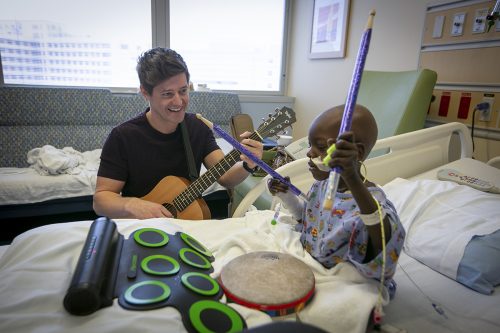 J Mack Slaughter accompanies Daniel as he rocks out on a drum set in his hospital room. Photo by Rodger Mallison