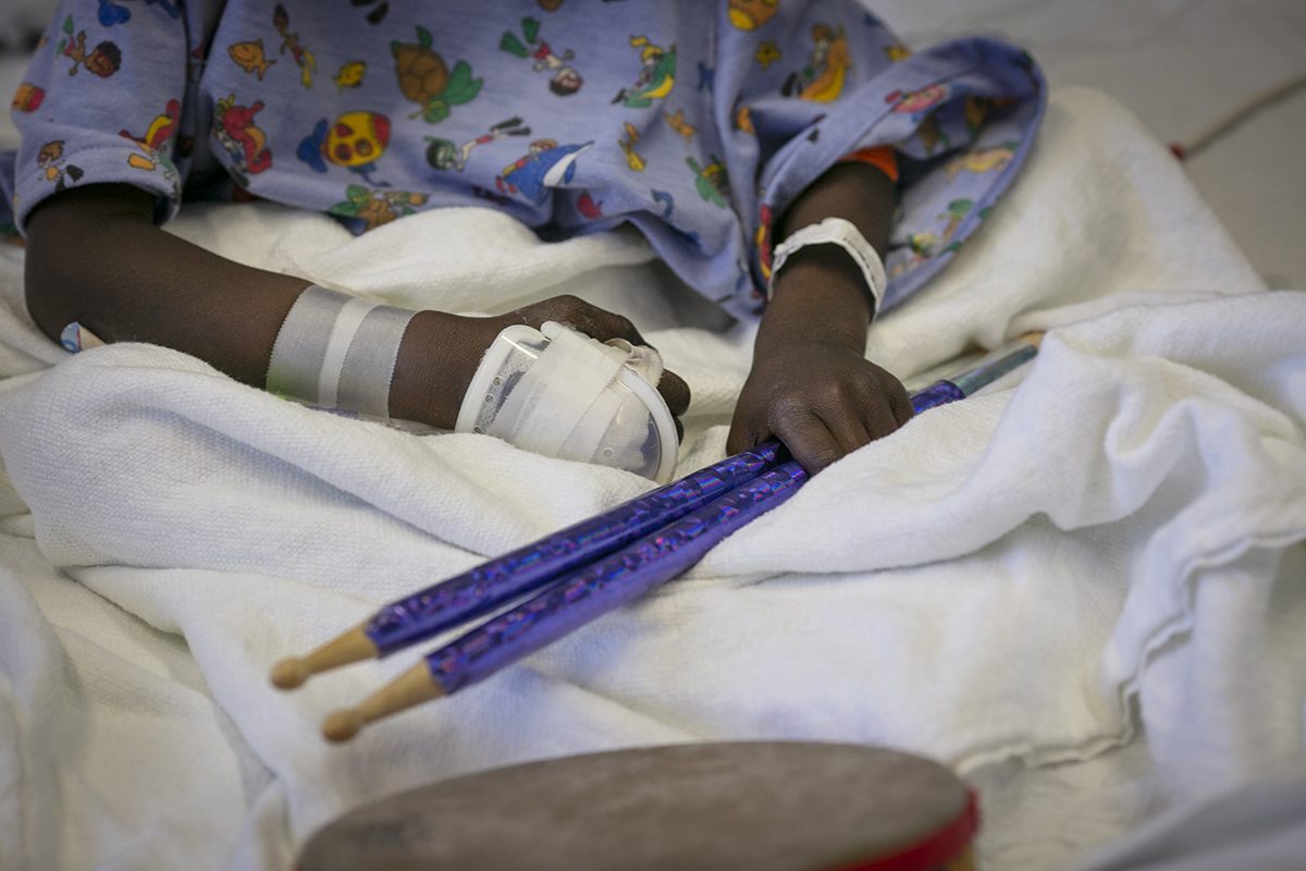 Daniel Smith, age seven, holds drumsticks for use with various percussion instruments he can play without leaving his bed at Children's Medical Center Dallas. The instruments were donated by Music Meets Medicine, a non-profit founded by pediatrician J. Mack Slaughter '09. The organization donates instruments and provides music lessons to patients in children’s hospitals. Photographed Thursday, January 31, 2019 by Rodger Mallison