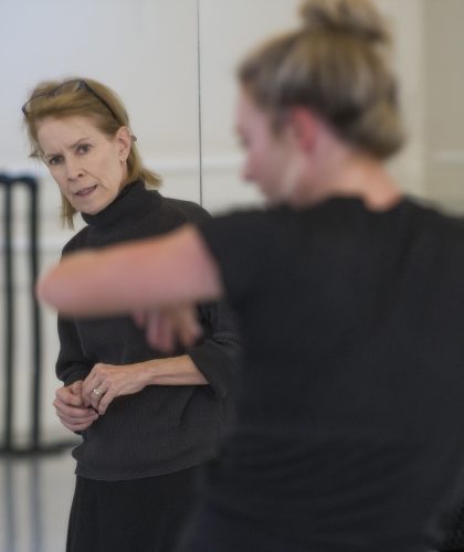Susan Douglas Roberts works with an older dancer during a rehearsal in Lowe Hall. Photo by Robert W. Hart
