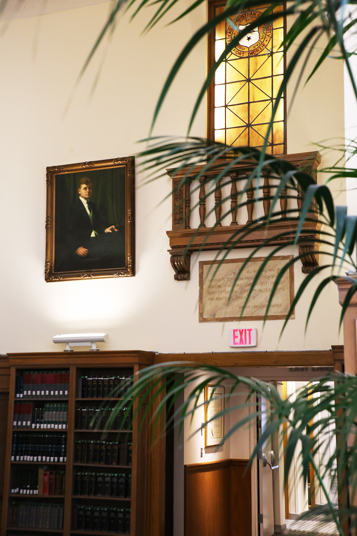 The painting hangs to the left of the Juliette balcony and stained glass window that are original to the library. Photo By Amy Peterson