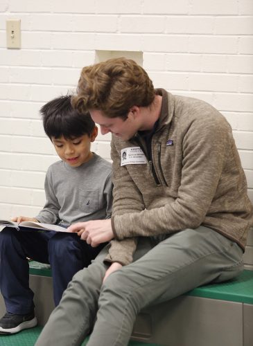 TCU student Matt Williams practices reading with Karim D'Avila Perez at Mary Louise Phillips Elementary school in Fort Worth. Photo by Ross Hailey