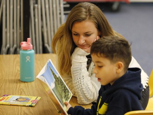 TCU student Victoria Becker practices reading with Jeriel Cotto at Mary Louise Phillips Elementary school in Fort Worth. Photo by Ross Hailey