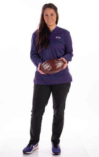 Brooke Helms, director of sports nutrition, holds the game ball from the October 2017 matchup against Kansas State that was riddled with weather delays. Head football coach Gary Patterson awarded her the ball for her efforts to keep the team sustained. Photo by Glen E. Ellman
