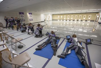 Members of the rifle team take their positions practice, including standing, kneeling and laying. Photo by Rodger Mallison