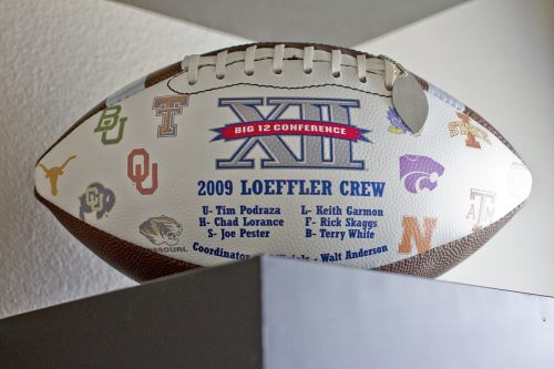 The mementos of NCAA referee Matt Loeffler includes commemorative footballs from when he worked the Big XII. Photo by Mark Graham