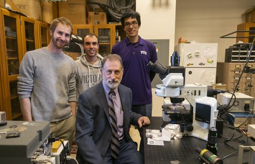 Karol Gryczynski works in his lab with research associate Joe Kimball, and graduate students Luca Ceresa and Jose Chavez as he studies fluorescence and its many uses in his laboratory in the Sid Richardson Building at TCU. Photo by Rodger Mallison