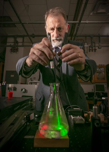 Karol Gryczynski, professor of physics in the physics and astronomy department of TCU's College of Science and Engineering, studies fluorescence and its many uses. Photo by Rodger Mallison