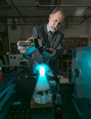 Karol Gryczynski investigates fluorescence as a tool in biomedicine. Photo by Rodger Mallison