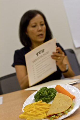 Carol Howe uses models of various foods to illustrate appropriate portions and healthy dietary choices for children. Photo by Mark Graham