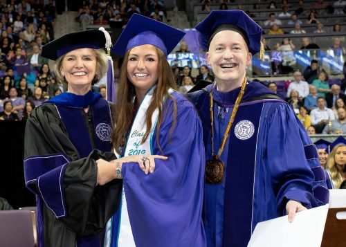 Allie Beth Allman celebrated the TCU graduation of her eldest granddaughter and namesake, Allie Beth Cowan, along with Chancellor Victor J. Boschini, Jr. Allman presented Cowan with her diploma during the May 2019 commencement ceremony and called the experience "one of the great joys of my life." Photo by Glen E. Ellman