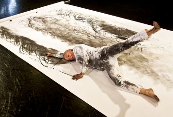 Nina Martin, associate professor of dance, performing her piece, Secondary Surface Rendered, which has been done with dancers of mixed ability. The work, done on white paper with charcoal, has been done with performers with cerebral palsy. This was done at the Erma Lowe Hall on the TCU Campus.