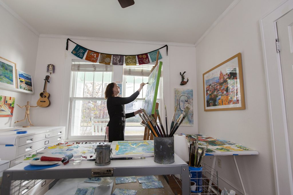 Artist Sylvia "Silky" Hart '81 paints and relaxes at her home studio in McKinney. Photo by Rodger Mallison