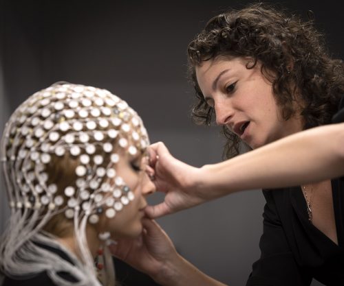In her lab at TCU, assistant professor of psychology Tracy Centanni attaches an EEG net to the head of third year psychology graduate student Kelly Brice. Photo by Joyce Marshall, Friday, January 10, 2020