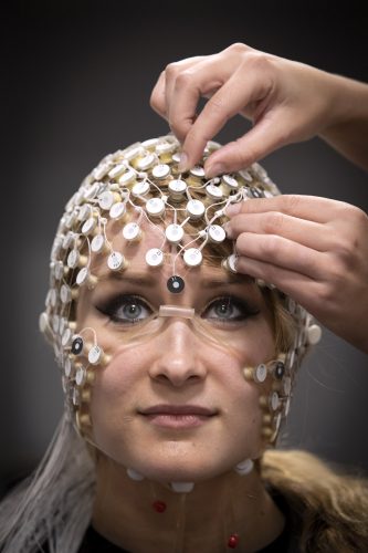 In her lab at TCU, assistant professor of psychology Tracy Centanni attaches an EEG net to the head of third year psychology graduate student Kelly Brice. Photo by Joyce Marshall, Friday, January 10, 2020