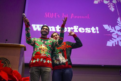 Dilan Shah and Quinn Losefsky wore sewn-together holiday sweaters to welcome students to the School of Medicine Winterfest, an event to help socially support the medical students. 