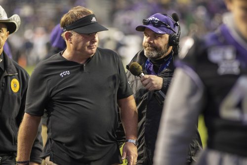 Landry Burdine grabs a quick interview with Coach Gary Patterson, after the first half, as he reports from the sidelines for the Horned Frogs Sports Network at the West Virginia vs.TCU game, November 29, 2019.