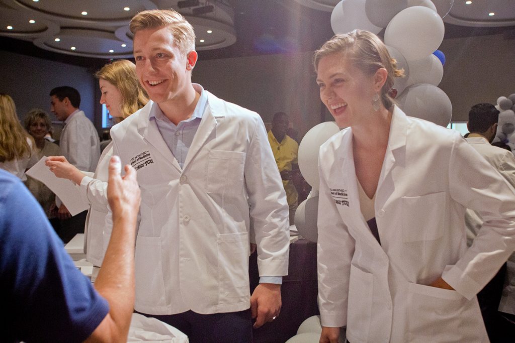 Jonas Kruse and Quinn Losefsky happily donned their new white coats in a celebration with friends and faculty in July 2019. 