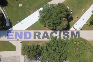 Aerial photo of the END RACISM mural, August 7, 2020. The mural project was spearheaded by Kellton Hollins and created with the cooperation of the Chancellor's office and campus leaders. All TCU faculty, staff and students were encouraged to sign their names to the mural in support of its message. Photo courtesy of TCU Athletics....