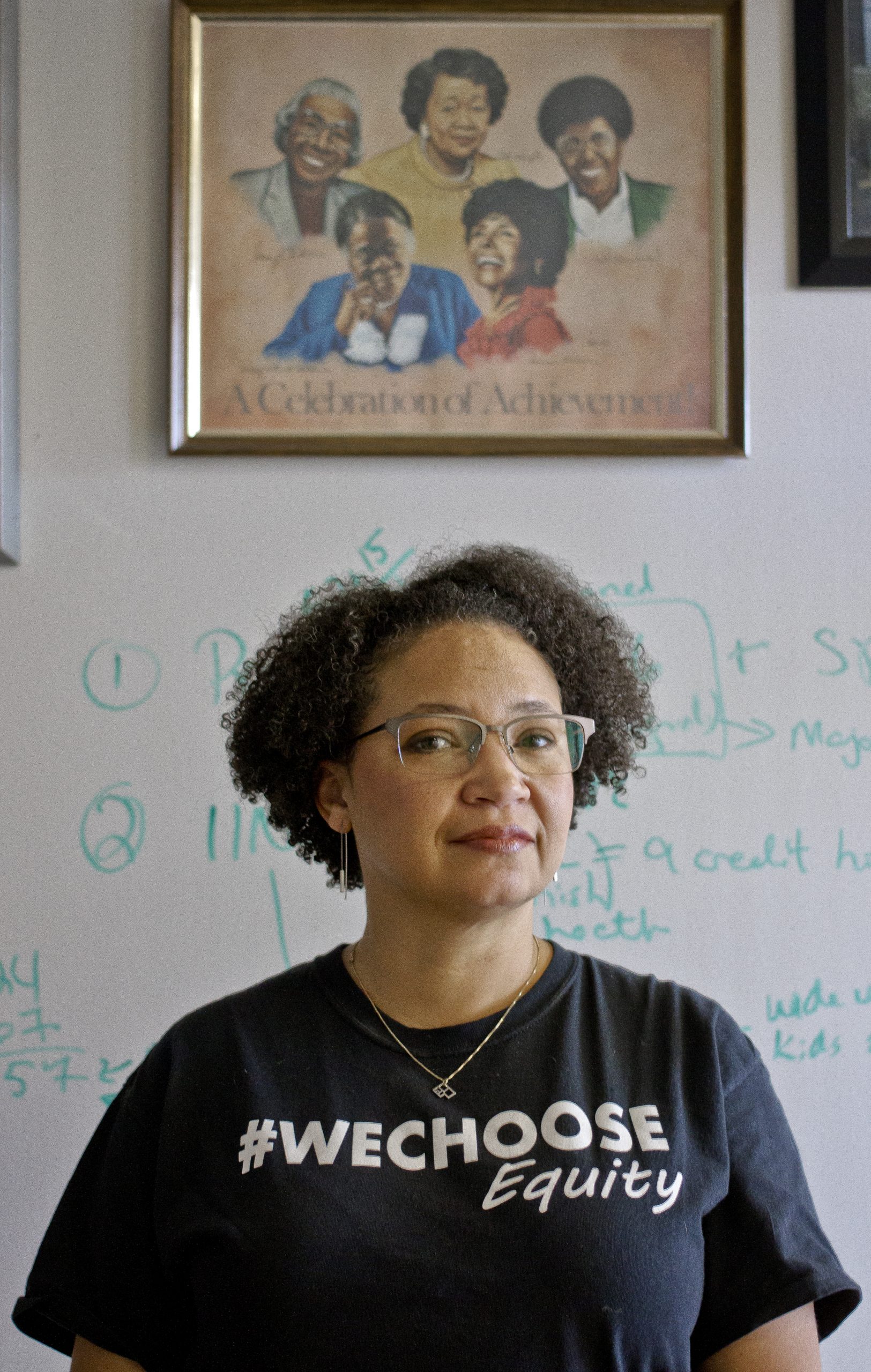 Francyne Huckaby, professor of education and associate dean of the School of Interdisciplanary Studies, in her office with a print of influential African-American women that graces her walls.